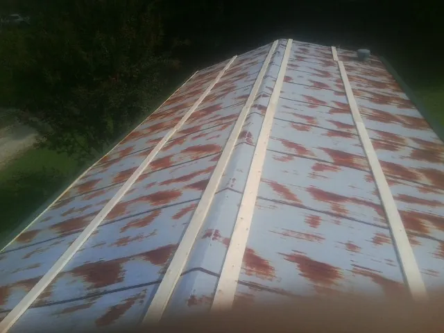 Rusted metal roof panels with new wood purlins before replacement — Storm Damage Roof Repair in Greenbelt by Roofing Brothers